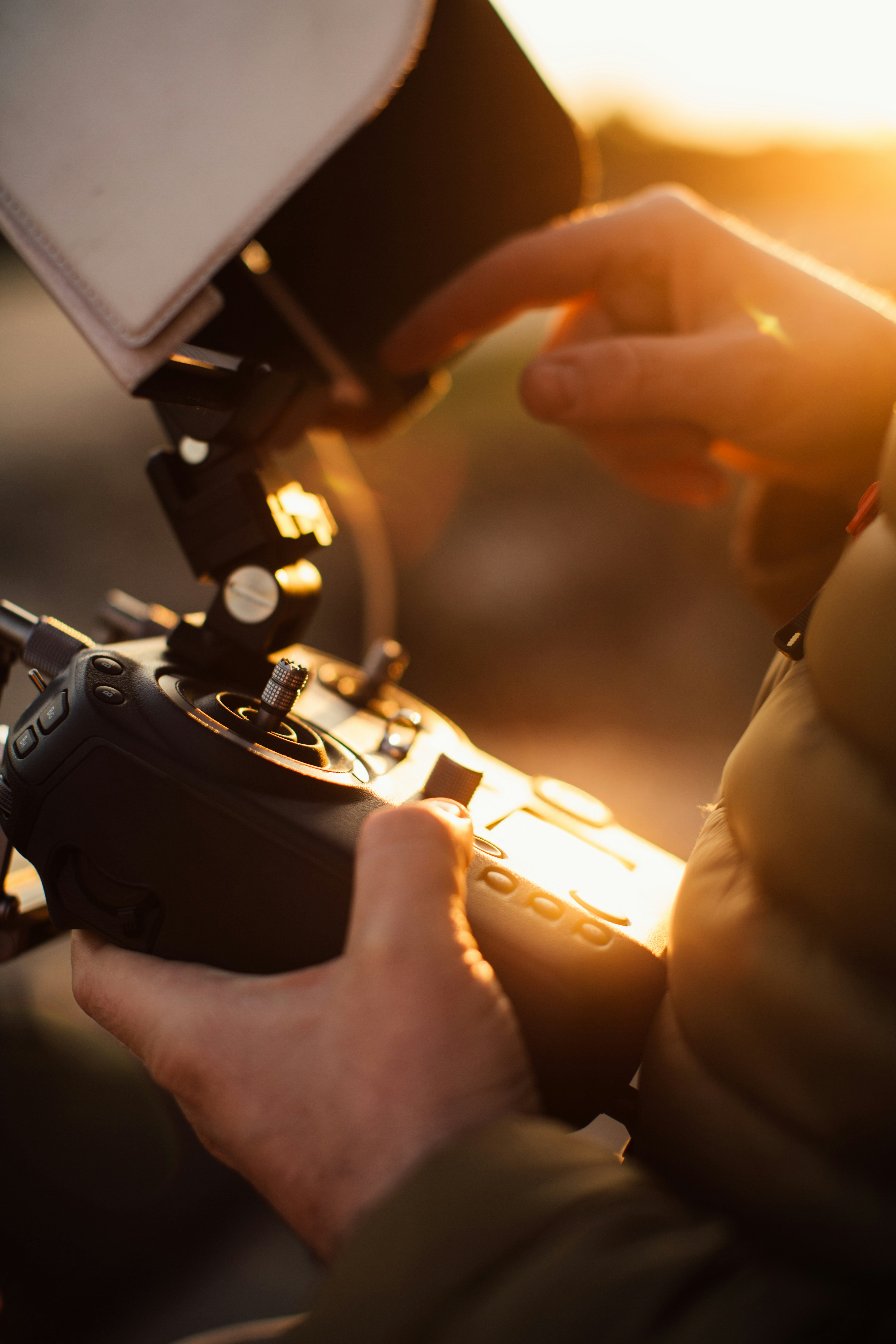 person holding black drone remote in selective focus photography